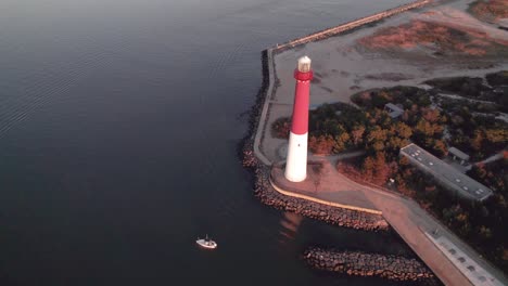 Aerial-drone-view-of-Barnegat-Lighthouse-revealing-Long-Beach-Island-in-the-background