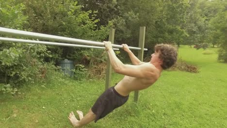 Atheltic-young-man-performs-Australian-Pullups-on-straight-bar-home-gym
