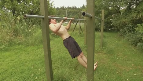 Young-man-performing-straight-bar-pulling-exercise-on-home-gym