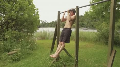 An-athletic-young-man-performs-close-grip-chin-ups