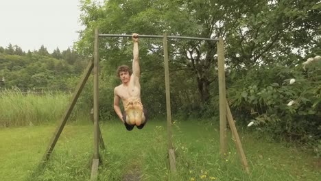 You-athletic-man-doing-one-armed-L-Sit-Hang-on-outdoor-home-gym