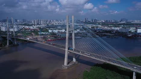 Aerial-view-of-Phu-My-Bridge-over-Saigon-river-with-road-and-river-transportation-on-a-sunny-day