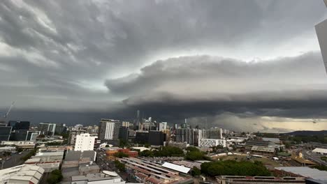 Handheld-motion-time-lapse-shot-capturing-dense-dark-layer-of-thunderstorm-clouds-covering-the-sky-in-Brisbane-city,-South-east-Queensland,-flash-flood-and-severe-weather-warning,-soaking-wet-season