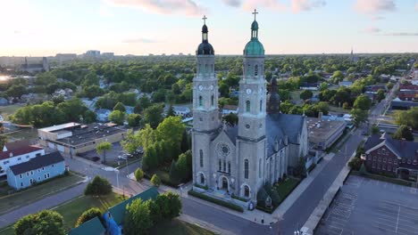 An-aerial-view-of-the-Saint-Stanislaus-B-and-M-Roman-Catholic-Church-spires-in-Buffalo,-New-York-in-the-light-of-the-setting-sun