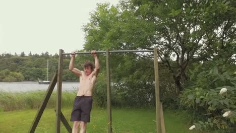 Fit-man-performs-consecutive-muscle-up-exercise-on-home-gym-within-nature