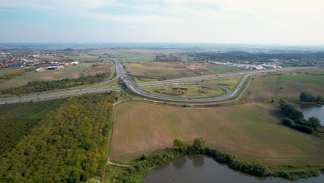Intersection-and-junction-of-an-expressway-in-the-vicinity-of-green-areas-and-water-reservoirs---Gdansk,-Borkowo,-Straszyn