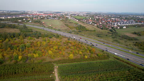 Expressway-placed-between-residential-area-and-natural-green-belt---trees-and-shrubs---Gdansk-aerial