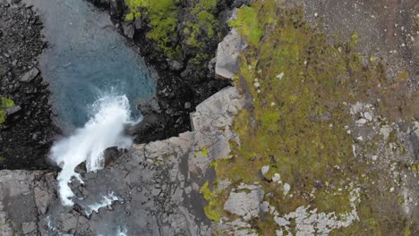 Aerial-of-Gufufoss-waterfall-in-Iceland-birdseye-view,-clear-blue-water
