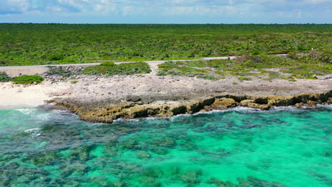 crystal-clear-Caribbean-water-on-rocky-coastline-in-Cozumel-Mexico-on-sunny-summer-day