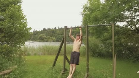 Athletic-young-man-doing-pullups-on-outdoor-home-gym-Slow-Motion