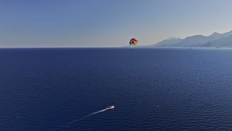 Antalya-Turkey-Aerial-v10-drone-flyover-capturing-parasail-flying-high-in-the-sky-above-deep-blue-see-overlooking-at-muratpaşa-coastal-cityscape-and-mountainscape---Shot-with-Mavic-3-Cine---July-2022