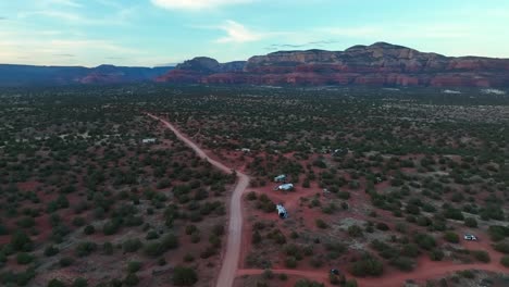 Fly-Over-Vehicles-And-Camper-Vans-In-Wild-Bushes-In-Sedona-Deserts,-Arizona