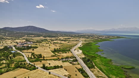 Beyşehir-Turkey-Aerial-v5-rural-landscape-view,-drone-flyover-lakeside-agricultural-farmlands,-capturing-crops-cultivation-farm-fields-in-hot-summer-season---Shot-with-Mavic-3-Cine---July-2022