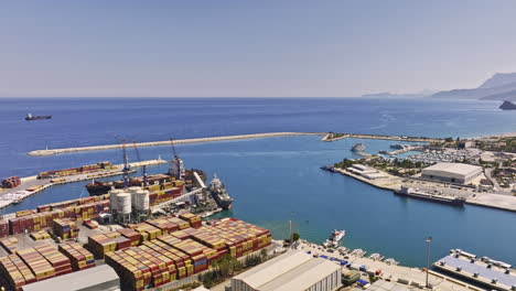 Antalya-Turkey-Aerial-v43-panning-view-flyover-shipyard-in-liman-sb-konyaaltı-with-commercial-ships-docked-at-the-harbor-and-logistic-shipping-warehouses---Shot-with-Mavic-3-Cine---July-2022