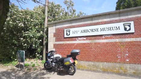 101.-Airborne-Museum-In-Bastogne,-Belgien-Mit-Davor-Geparktem-Motorrad