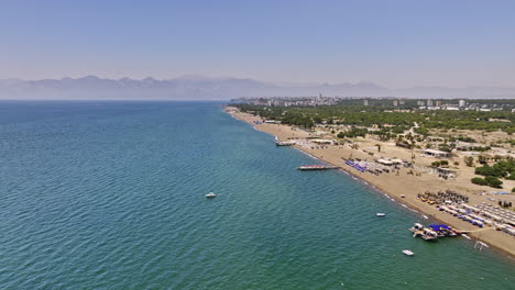 Antalya-Turkey-Aerial-v26-cinematic-drone-flyover-famous-coastline-lara-beach,-the-blue-flag-destination-in-güzeloba-muratpaşa-on-a-sunny-day-in-summer---Shot-with-Mavic-3-Cine---July-2022