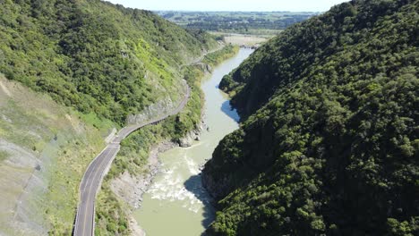 Flying-through-the-Manawatu-Gorge,-over-the-abandoned-road,-New-Zealand