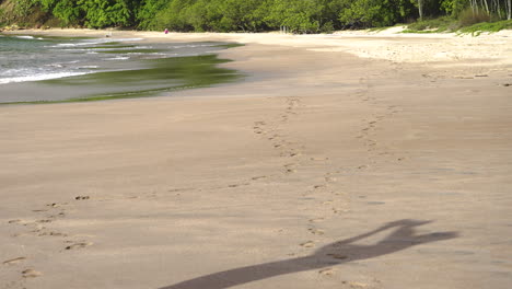 male-shadow-tourist-taking-a-photo-in-tropical-beach-seascape