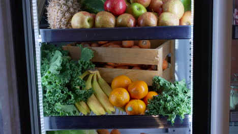 Close-up-shot-of-close-fridge-filled-with-green-vegetables-and-different-types-of-fruits