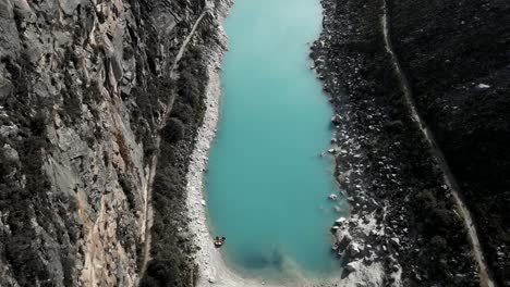 Aerial-Above-Laguna-Paron-Turquoise-Water-Peruvian-Andes-Lake-Between-Mountains-and-Pyramid-Peak,-Trekking-Travel-Destination-in-the-Cordillera-Blanca,-Peru
