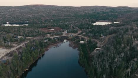 Aerial-Panoramic-View-Of-Forest-Lake-With-Cabins-By-The-Shore-In-Saint-Come,-Quebec,-Canada