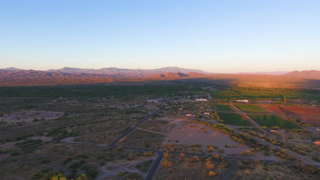 Panning-drone-shot-of-large-patches-of-land-with-mountains-in-the-background-located-in-Flagstaff-Arizona