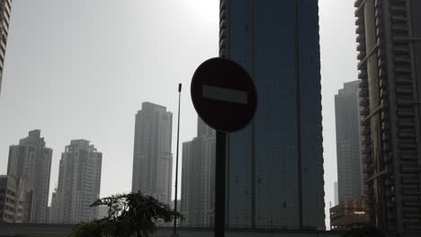 Stop-sign,-traffic-sign,-middle-eastern,-Dubai,-skyscraper,-downtown,-buildings,-cityscape,-city-life,-architecture,-building,-skyline,-cities,-urban,-middle-east,-United-Arab-Emirates,-UAE