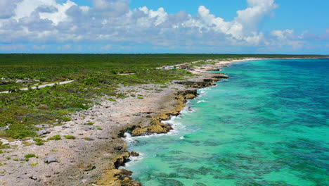 aerial-panoramic-of-lush-green-Cozumel-island-coastline-with-turquoise-blue-water-in-Mexico-on-sunny-summer-day