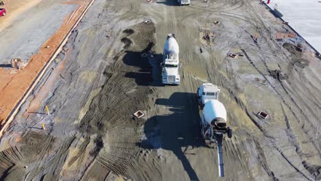 A-massive-line-of-concrete-trucks-drives-past-each-other-at-a-construction-site