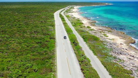 wide-aerial-panoramic-of-car-on-empty-uninhabited-island-with-beautiful-turquoise-water-and-white-sand-beaches-in-Cozumel-Mexico