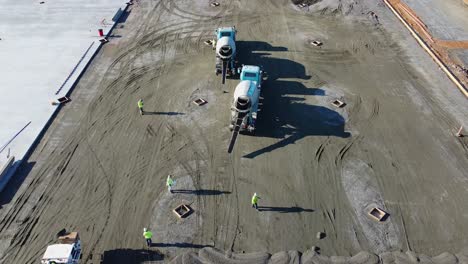 A-concrete-mixing-truck-drives-away-from-a-concrete-pad-it-just-poured