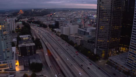 Aerial-view-of-vehicles-driving-on-the-freeway-to-enter-and-exit-Seattle-during-the-evening