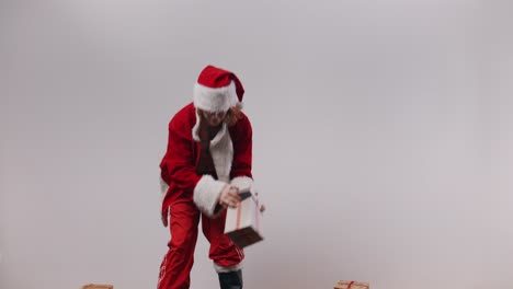 Terrible-Santa-Jake-tries-to-balance-a-stack-of-presents-and-fails-miserably,-then-decides-to-down-a-can-of-beer