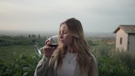 Beautiful-Blond-Woman-Drinking-Red-Wine-With-Nature-Background