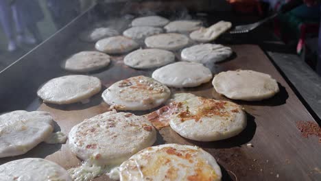 Pupusas-a-traditional-salvadoran-food-being-cooked-in-hot-griddle-close-up