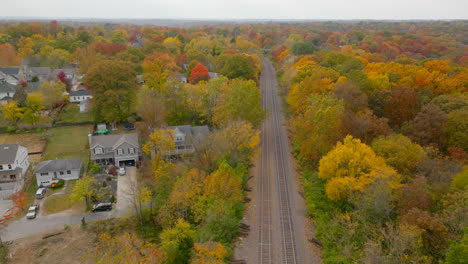 Aerial-over-train-tracks-going-through-Kirkwood,-Missouri-in-St