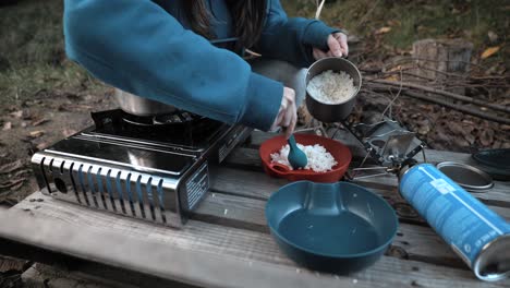 taking-rice-out-of-a-pot-in-the-Nature,-Outdoor,-Camping