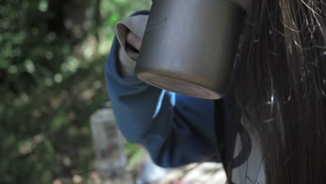 woman-drinking-a-soup-in-the-Nature,-Outdoor,-Camping