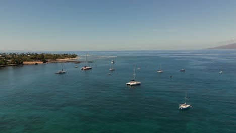 Aerial-Over-Kahoma-Stream-Off-West-Maui-Flying-Over-Moored-Catamarans-With-View-Of-Lanai-Island-In-The-Background
