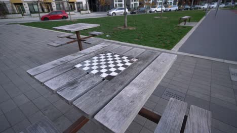 Pan-of-outdoor-chess-picnic-table-at-park,-empty-no-people