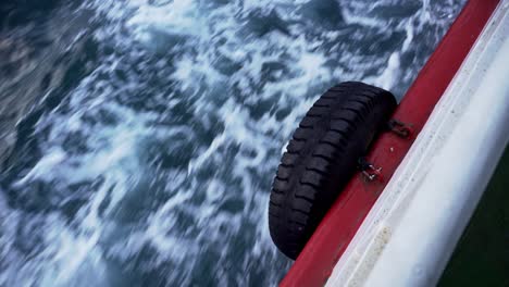 Car-tire-on-the-side-of-the-boat,-while-moving-over-the-sea-in-Istanbul