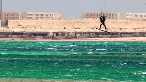 Talented-Windsurfer-jumps-High-on-Hurghada-Beach,-Egypt-Windsurfing-Water-Sport-in-Touristic-Red-Sea-Destination,-60-Fps