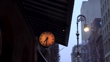 Clock-showing-six-thirty-one-in-the-morning-during-snowy-morning-in-Soho,-Manhattan,-New-York