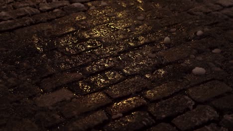 Close-up-of-cobble-stones-in-Soho-New-York-as-they-shimmer-during-early-morning-snowfall