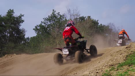 Quad-bike-riders-jump-over-a-hill-during-tournament