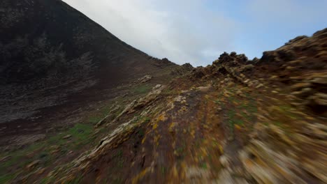 fuerteventura-vulcan-FPV-aerial-dive-in-from-rocky-ridge-slowmotion-50fps