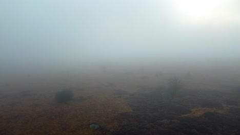 Heavy-fog-over-rural-fields,-aerial-drone-ascend-view