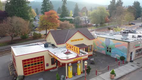 Drone-of-small-town-retro-gas-station-with-Christmas-lights