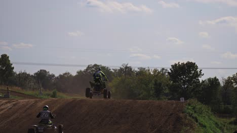 Several-quad-bikes-jump-over-the-hill-during-race