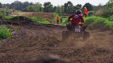 Slow-motion-quad-bike-coming-onto-a-curb-on-dirt